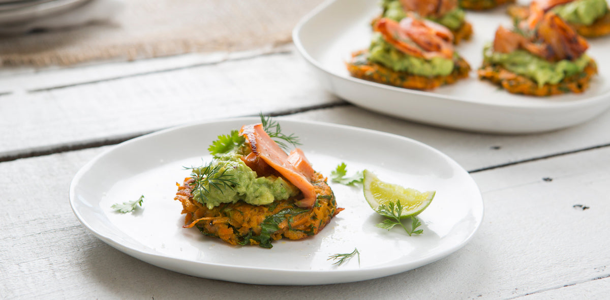 Sweet potato fritters topped with smashed avocado and salmon