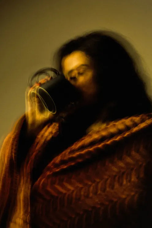 A cup of coffee on a desk in soft afternoon light